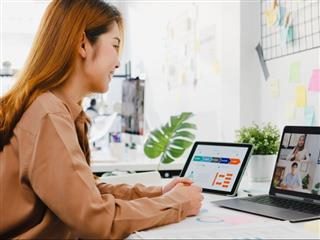 A female developer collaborating remotely with other developers and stakeholders - Developer Portal Concept