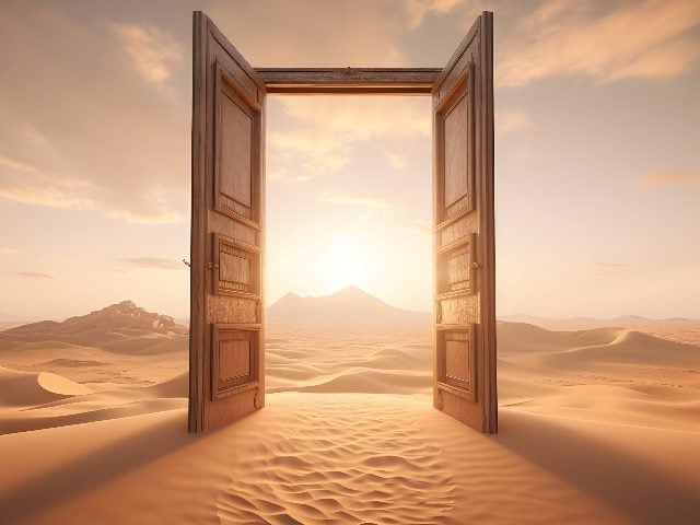 Opened door on desert with sand on the ground and the sun and sky in the background suggesting the benefits of generative AI.