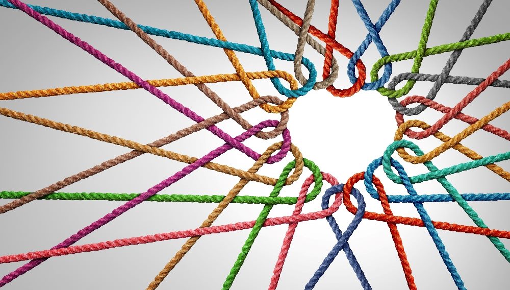 Colorful pieces of rope in red, yellow, green, blue, brown and purple are connected together in a way that forms at heat at the center in piece about customer retention strategies and connections.