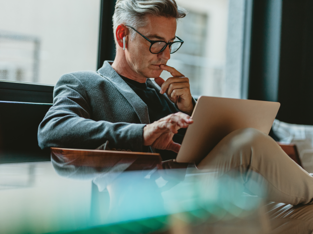 A businessman reading about generative AI's impact on CX.