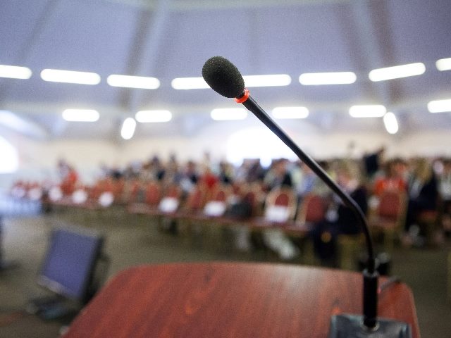 Microphone on stand in front of audience.