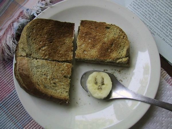 three pieces of toast and a banana slice on a spoon