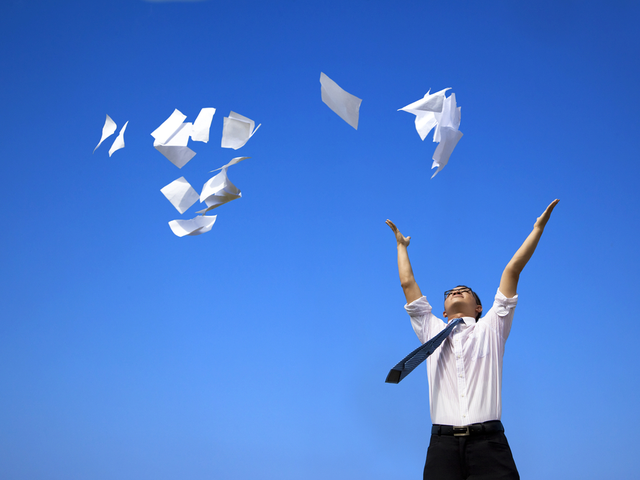 A man throwing documents in the air