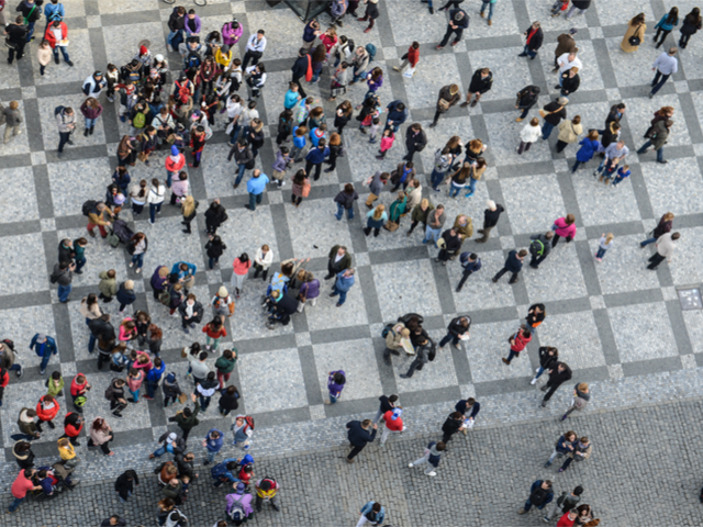 A crowd of people being viewed from a birds eye view.