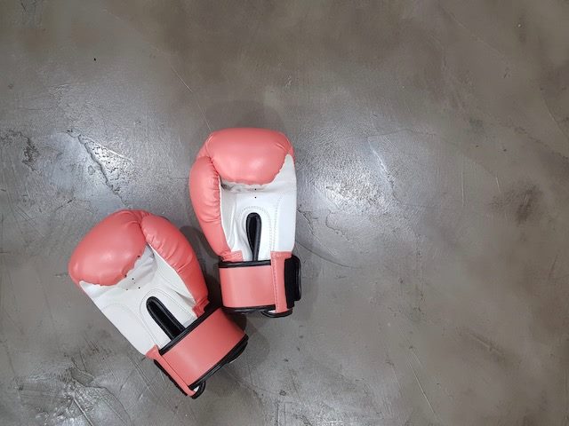 pair of boxing gloves on cement floor