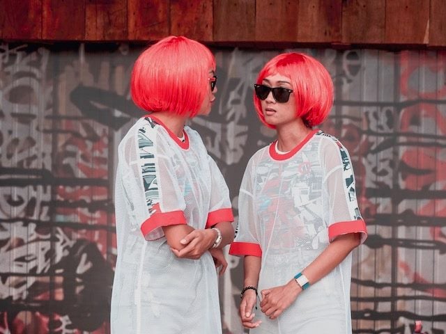 two women dressed in identical outfits