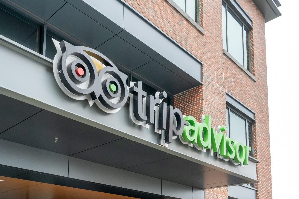 Tripadvisor logo sign on its headquarters building in Needham, Mass., in piece about customer loyalty strategies.