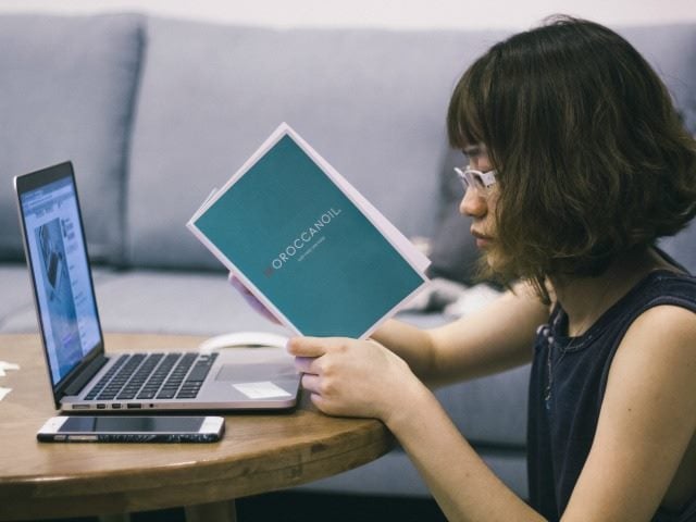 reading a book at the computer