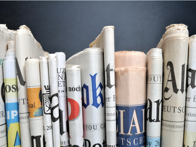 stack of newspapers standing upright.