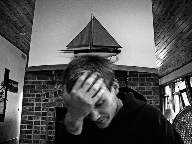 man holding head in frustration