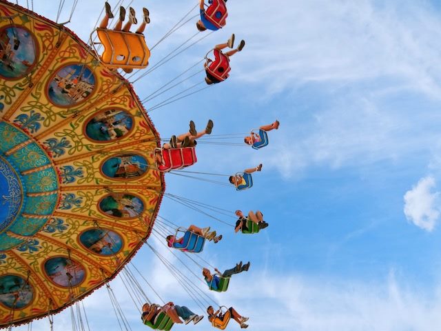 partial view of a carnival ride with swings 