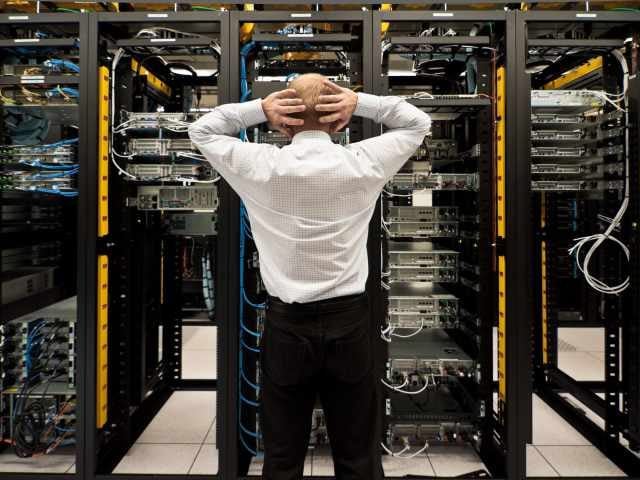 Man looking astonished in a network data center.