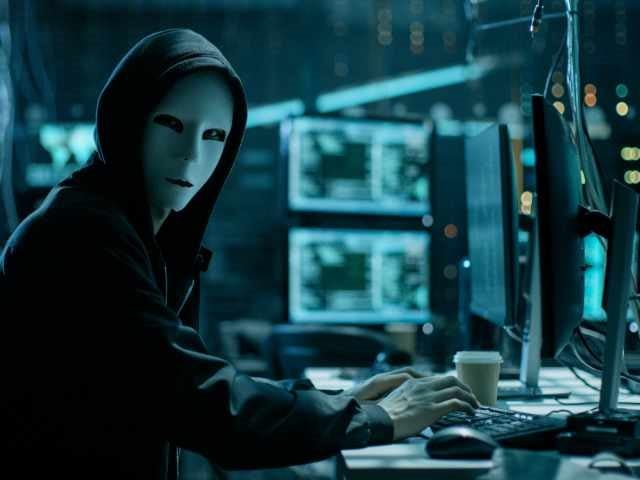 Hacker stealing confidential data from a PC terminal