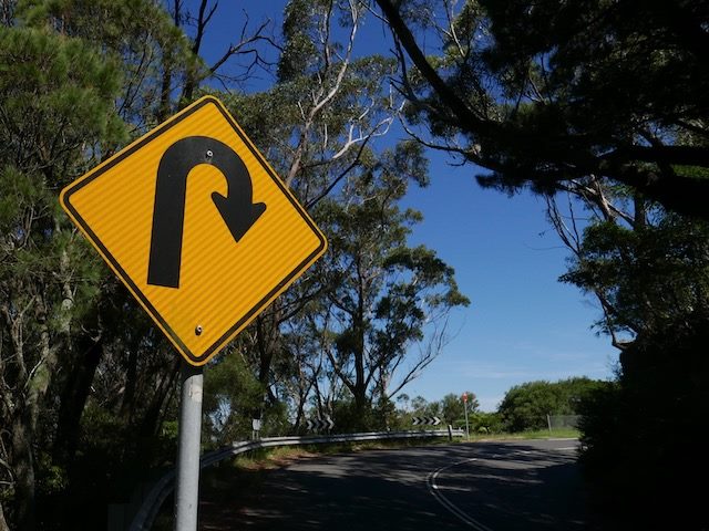 u-turn sign on the side of the road