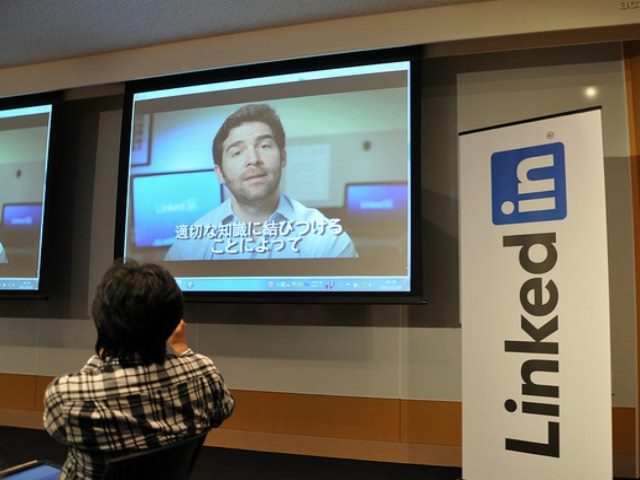 person looking at tv screen with linkedin logo to right