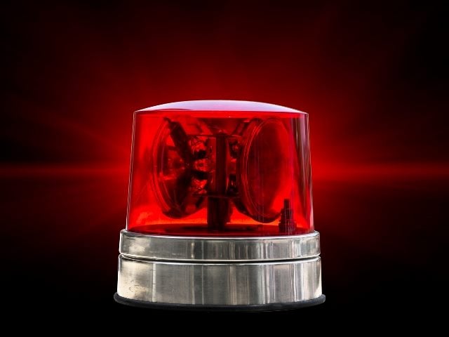 A red flashing emergency light of the type used atop emergency vehicles representing social media PR crisis response plans,