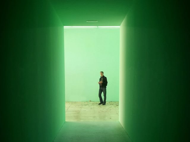 man at the end of  a  green tunnel