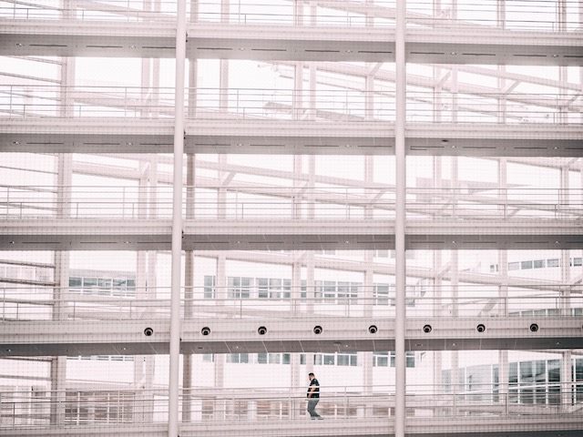 solo person walking through empty hallways of a building