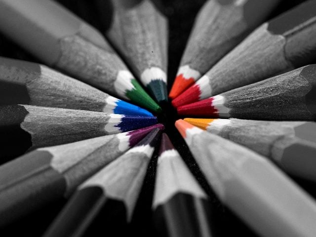 Colored pencils on black background.