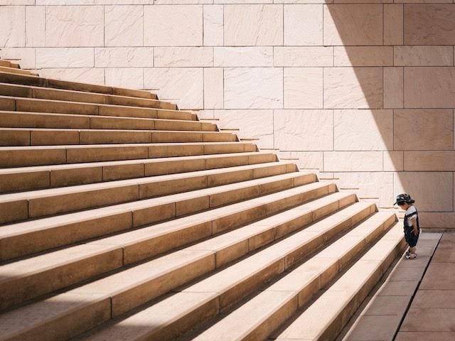 child facing  a long set of stairs
