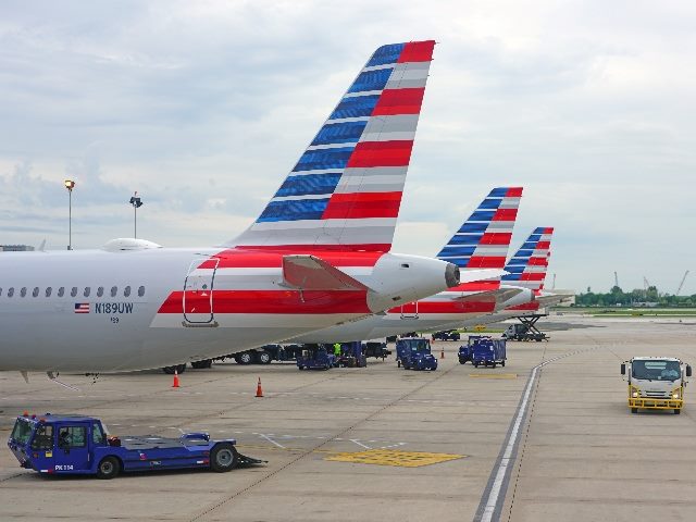 \Airplanes from American Airlines (AA) at the Philadelphia International Airport (PHL) in Pennsylvania. How do its cuts affect customer service automation?