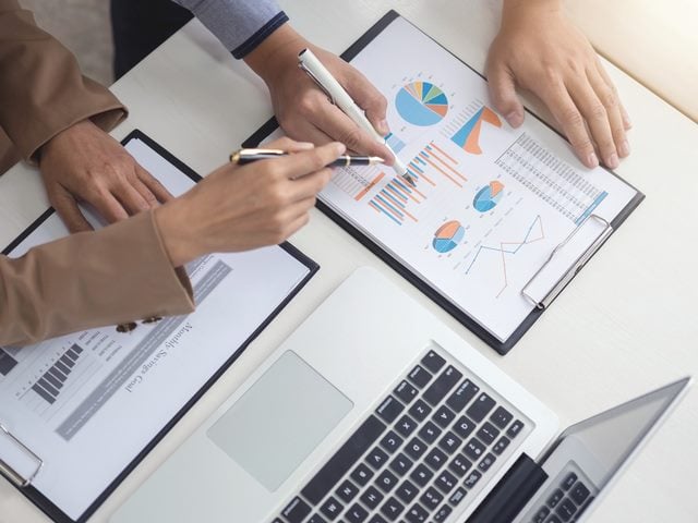 A senior executive using real-time financial data to plan a new project investment other office worker.