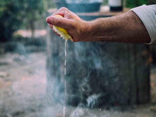 squeezing a piece of citrus