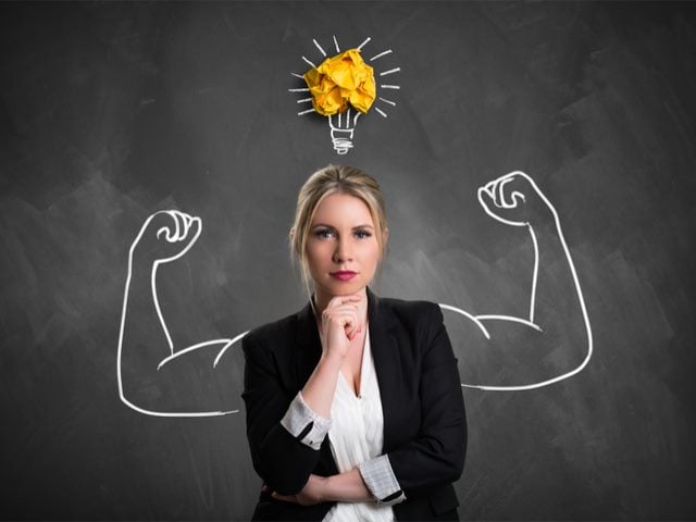 Businesswoman with drawing symbolizing power and having an idea