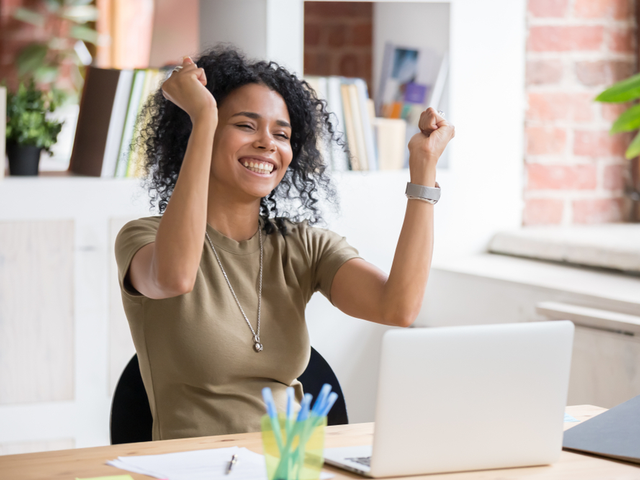 A businesswoman excited that she just finished a semester of online learning - digital literacy concept