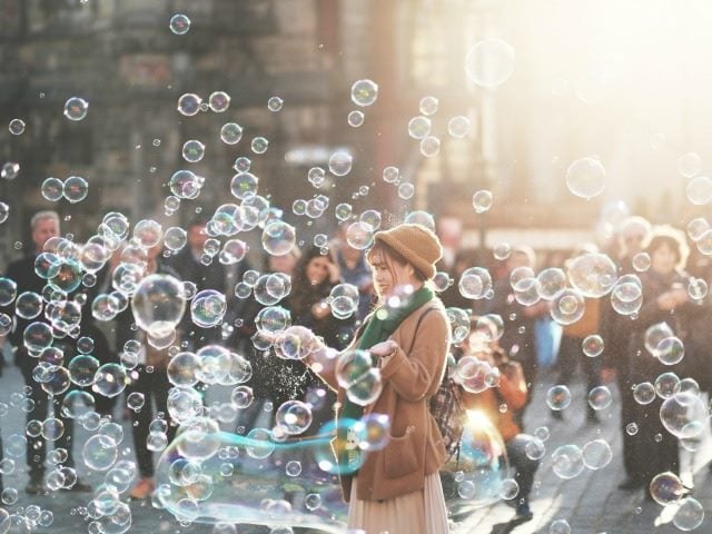 woman blowing soap bubbles