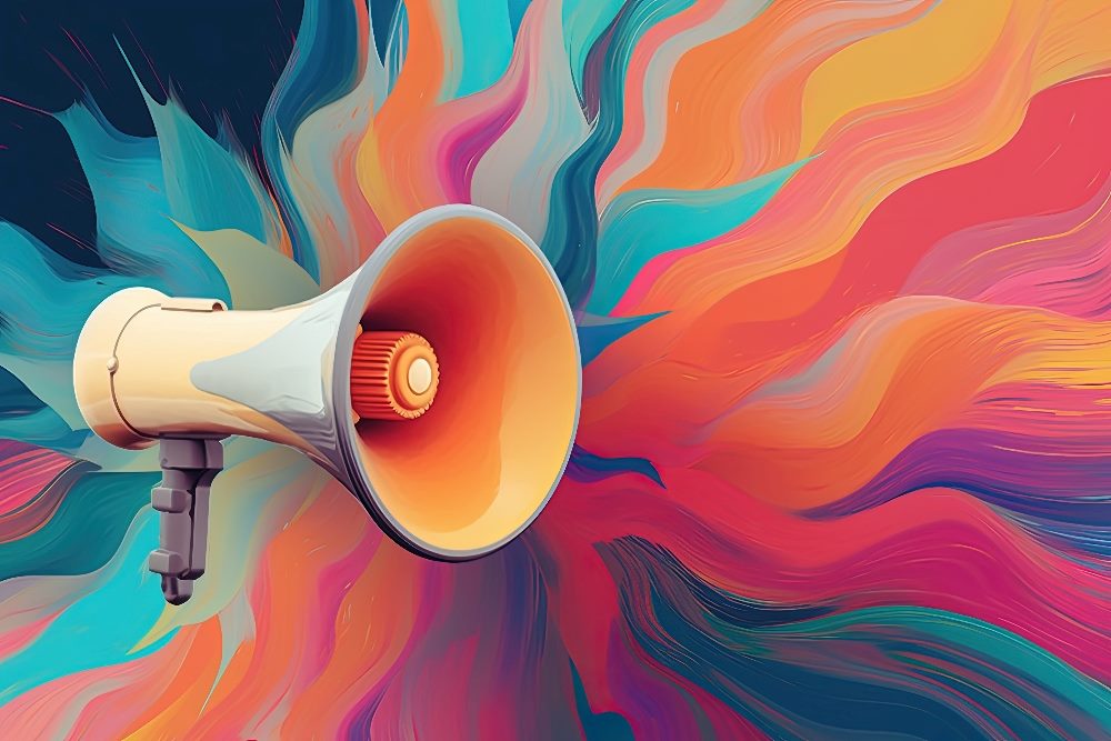 An orange and gray megaphone on a multi-colored bright backgroun, suggesting the importance of voice of the customer strategies.
