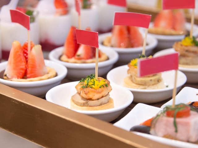 Finger foods served on wooden slate platter. 