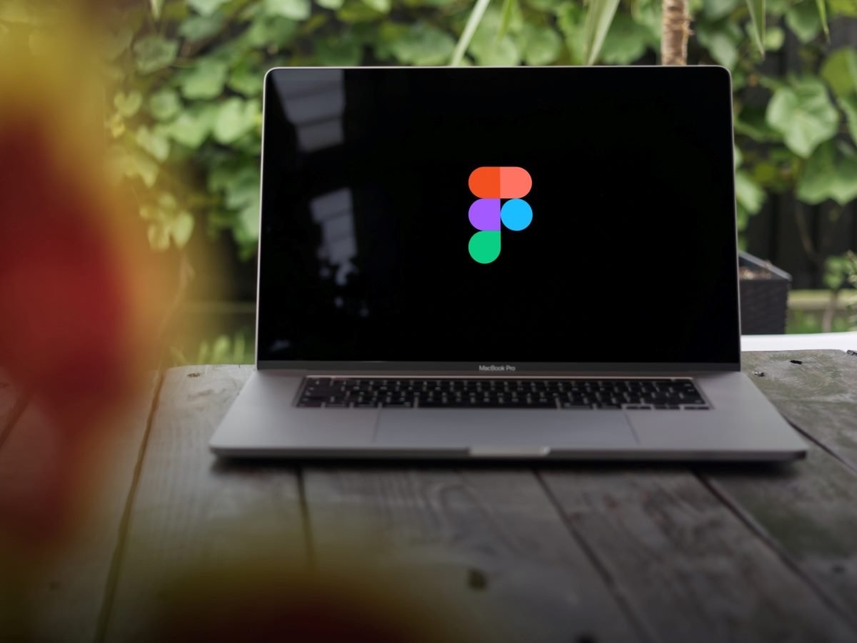 Figma logo, displayed on a MacBook Pro screen.