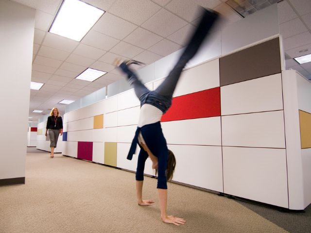Woman doing a cartwheel at work