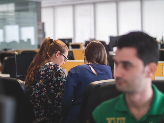 two co-workers having a conversation