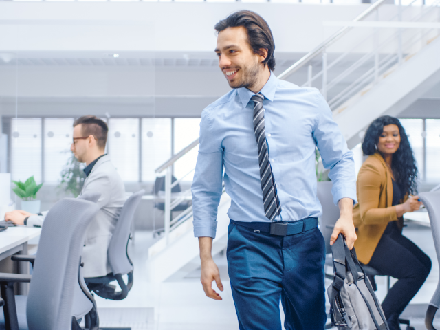 Businessman Returns to Work After COVID Break From the Office Space