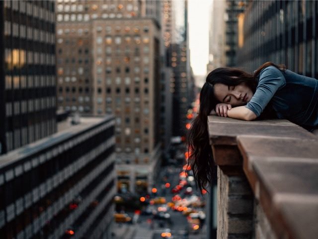 taking a nap on a parapet wall, 40 floors above traffic