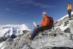 Male Mountain Climber with Computer
