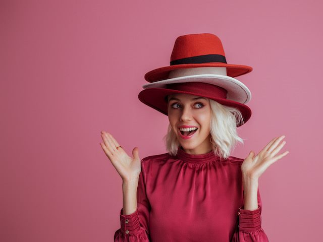 woman wearing many hats