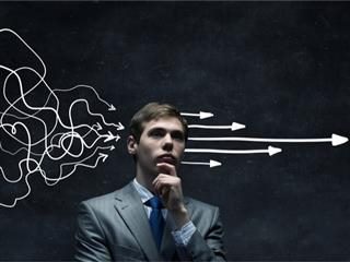 Thoughtful businessman contemplating which CRM to choose