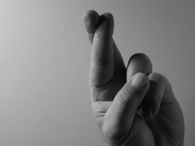 fingers crossed for good luck after making a wish