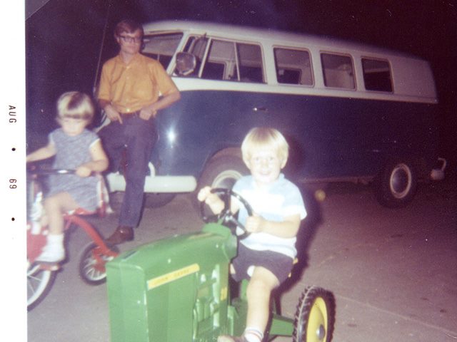 Two children riding bikes while father watched from the background in 1969. 