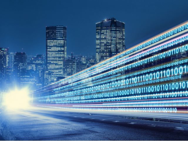 night cityscape with bright light and digital code in foreground