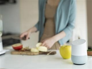 prepping food with smart speaker in the foreground