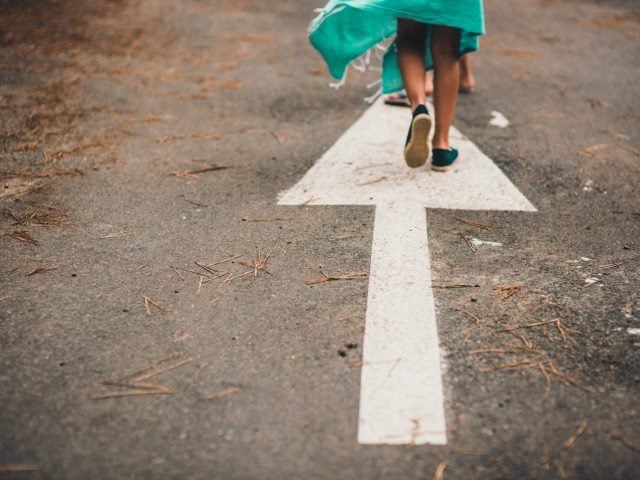 arrow on road, someone walking on it