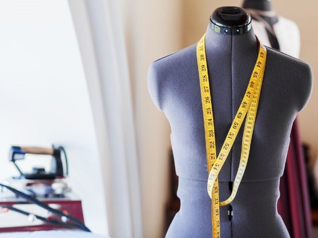 A sewing bust with a measuring tape around it 