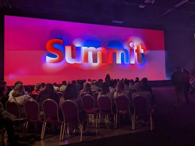 Shot of large screen that says, "Summit" from the Adobe Summit keynote on March 26, 2024 at the Venetian Hotel in Las Vegas.