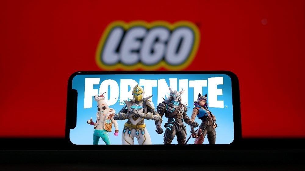 The Lego name and logo is in the red background and the Fortnight name with characters is displayed on a smartphone in piece about consumer trends and AR, VR and AI.