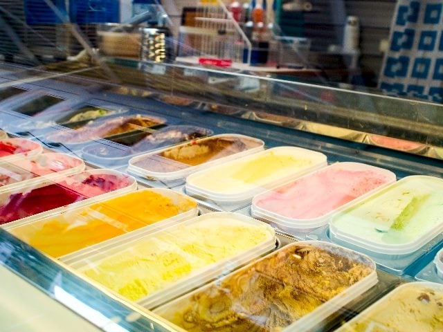 Ice cream flavors behind the glass at store. 