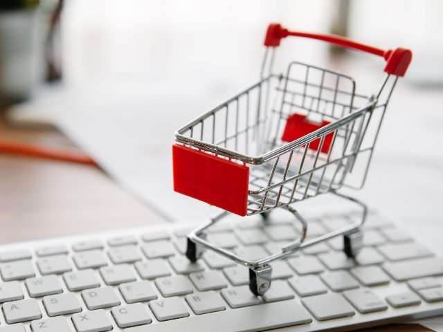 Shopping cart on a laptop keyboard. 